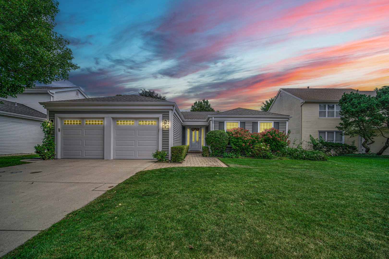 933 Shambliss Lane Buffalo Grove, IL 60089 - Photo 2 of 29 a front view of a house with a yard and garage