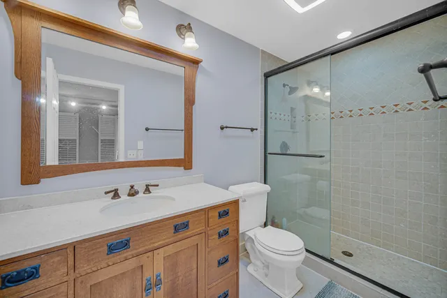 a bathroom with a sink toilet and shower