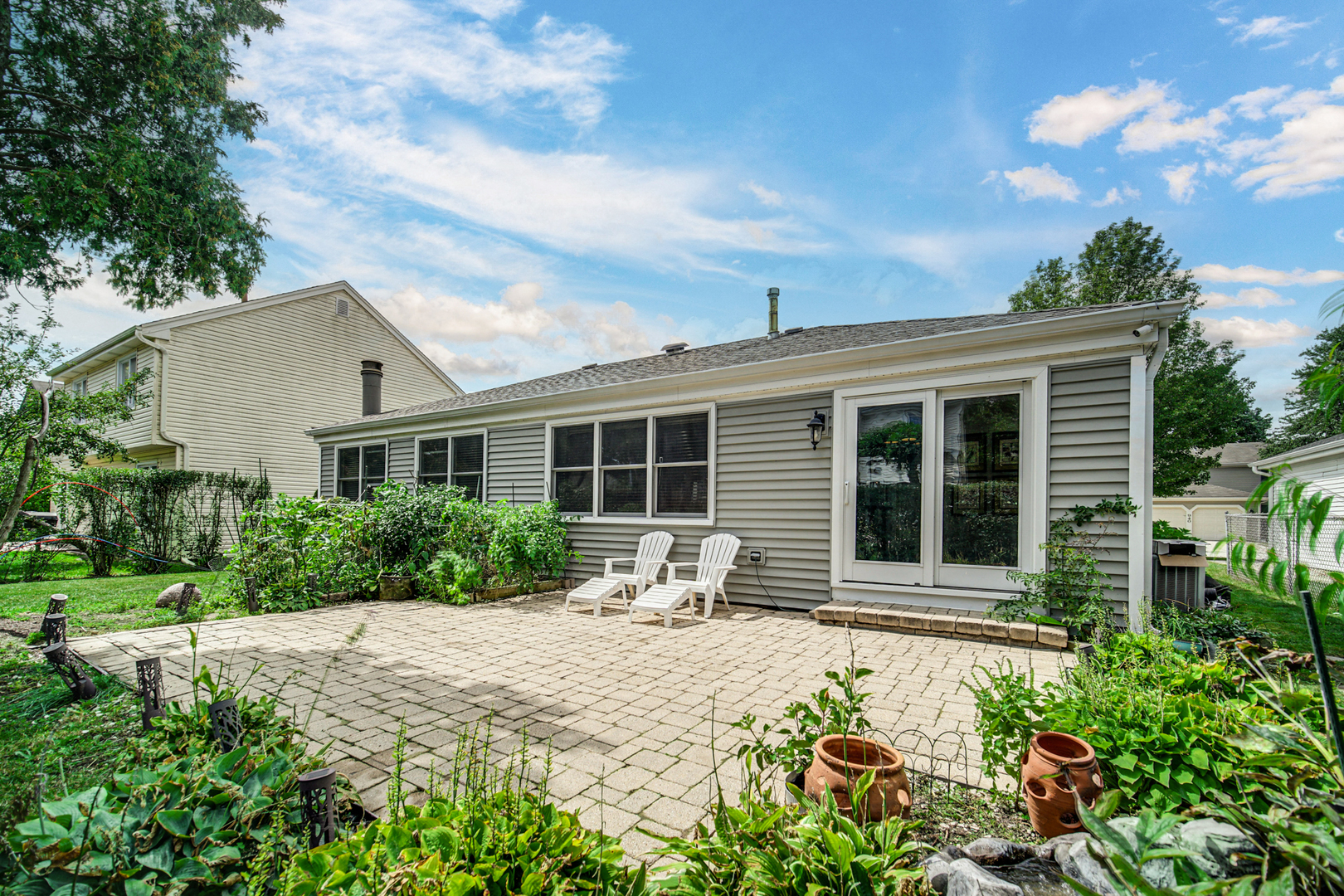 933 Shambliss Lane Buffalo Grove, IL 60089 - Photo 28 of 29 a front view of a house with a yard and potted plants