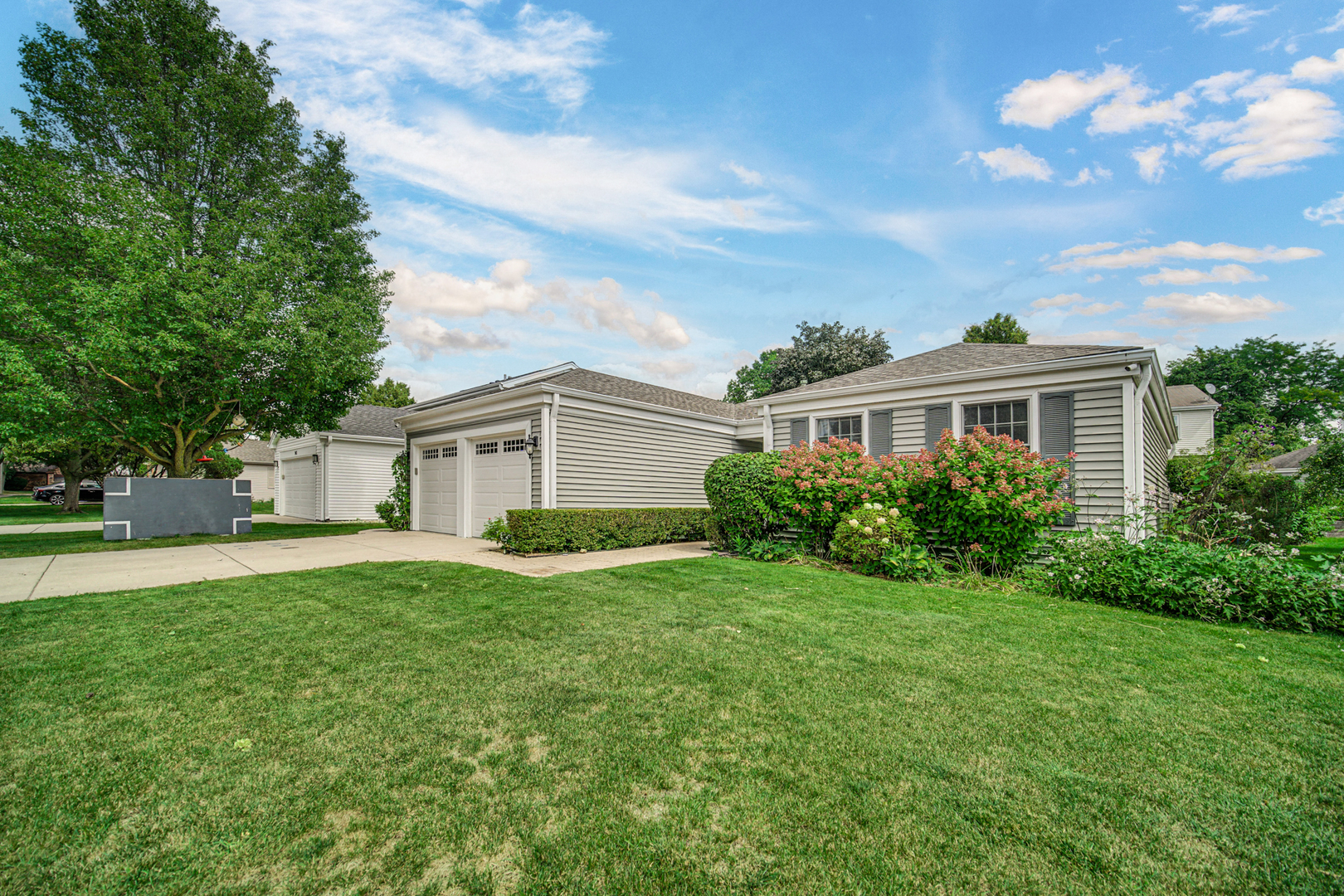 933 Shambliss Lane Buffalo Grove, IL 60089 - Photo 3 of 29 a view of a yard in front of a house with large windows
