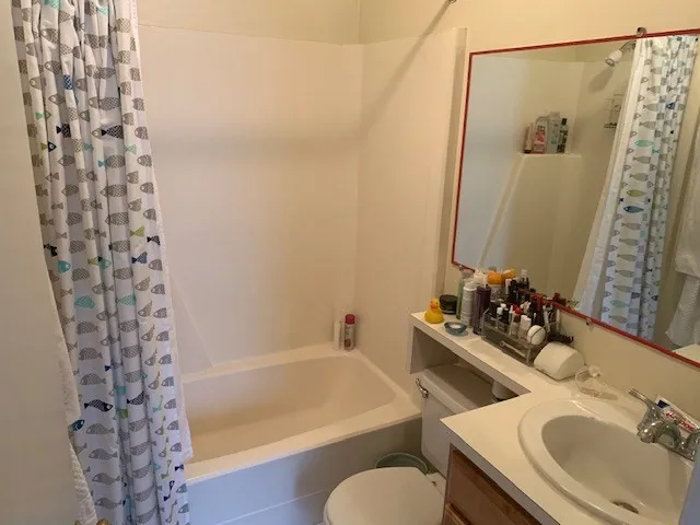 a bedroom with a bed next to a window