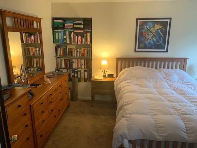 a large bed sitting in a bedroom next to a window