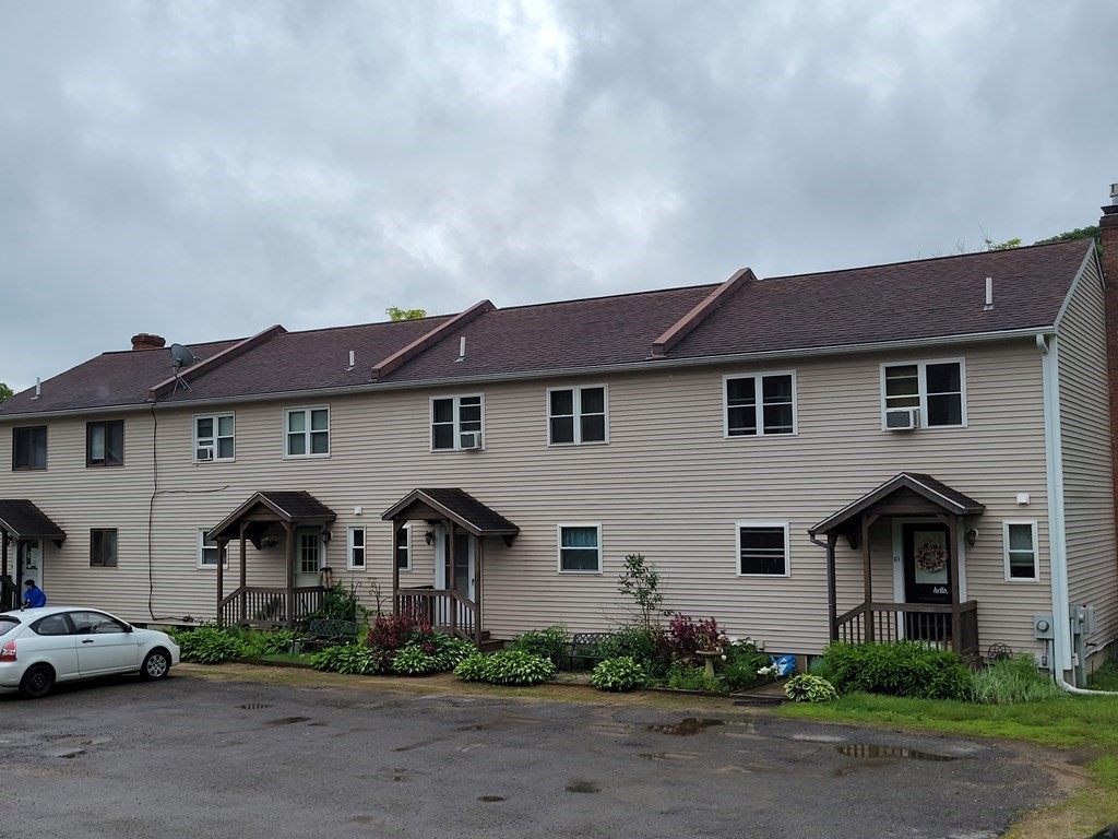 111 Brickyard Road, Unit 3G Athol, MA 01331 - Photo 1 of 16 a front view of a house with a yard and garage