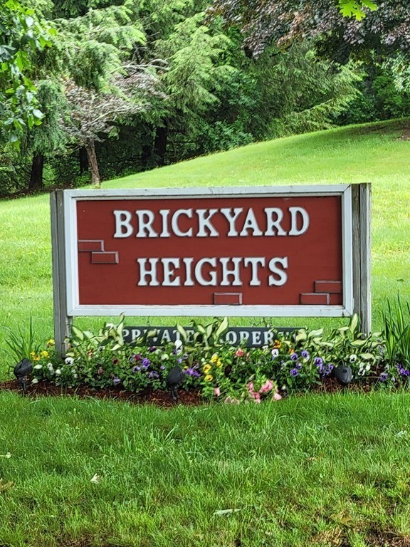 111 Brickyard Road, Unit 3G Athol, MA 01331 - Photo 2 of 16 a sign broad in front of red brick house