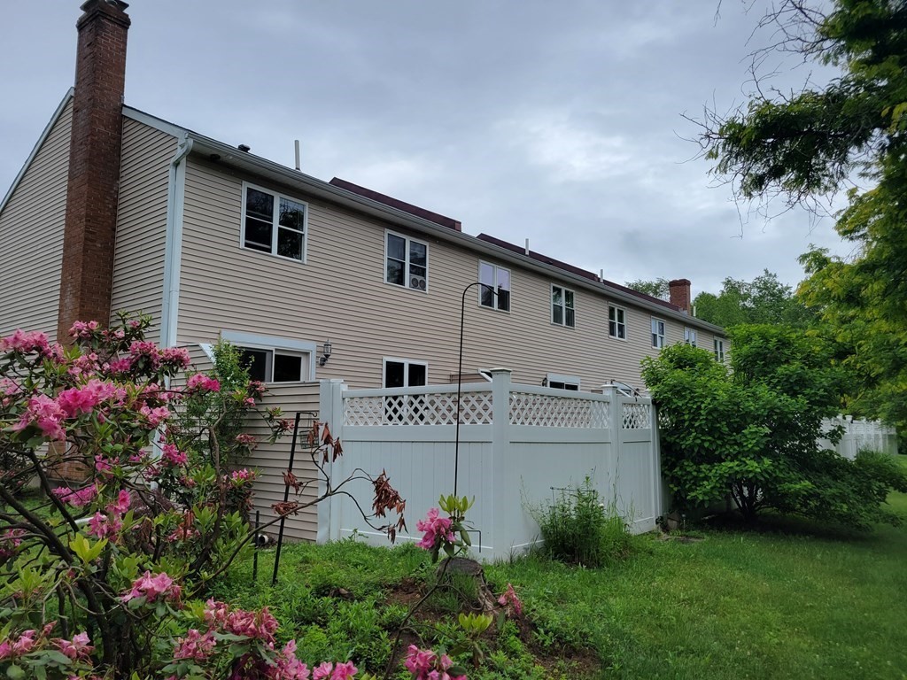 111 Brickyard Road, Unit 3G Athol, MA 01331 - Photo 3 of 16 a view of a white house with a big yard and potted plants