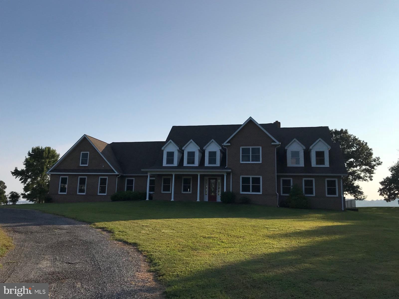 1970 Potts Point Road Huntingtown, MD 20639 - Photo 1 of 2 a front view of a house with a garden