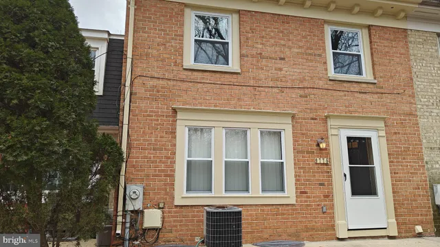 a view of a brick house with a large windows
