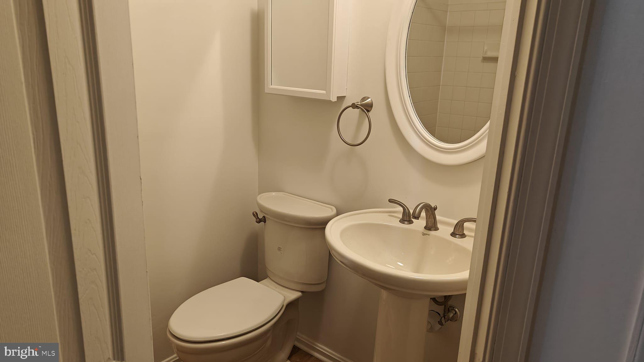 9776 Whiskey Run Laurel, MD 20723 - Photo 17 of 23 a bathroom with a sink a toilet and a mirror