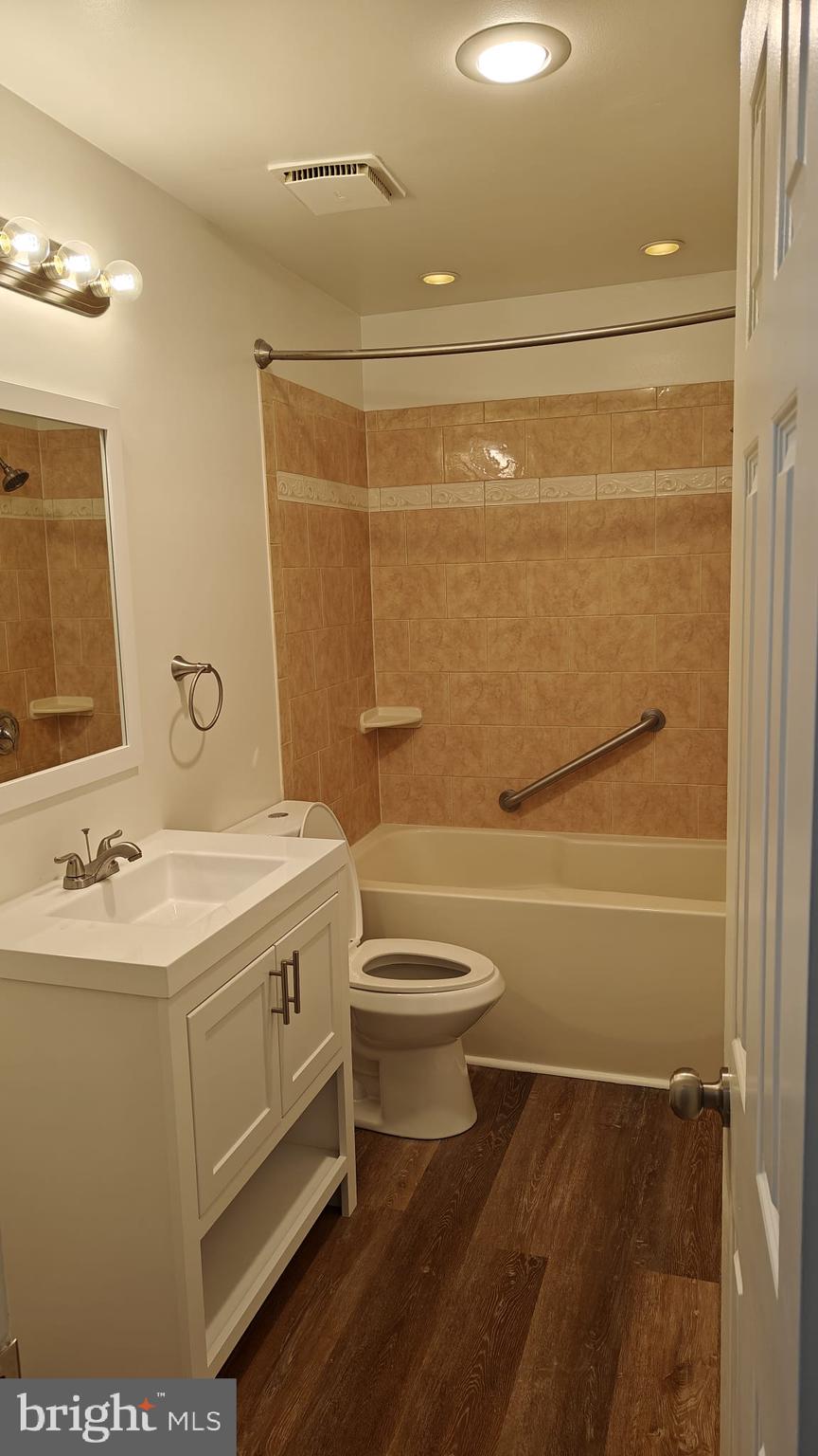 9776 Whiskey Run Laurel, MD 20723 - Photo 8 of 23 a bathroom with a sink a toilet and shower