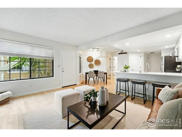 a living room with furniture and kitchen view