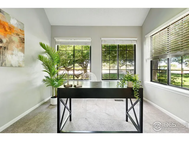 a bathroom with a sink a toilet a mirror and shower curtain