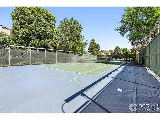 a view of a chair and table in the garden