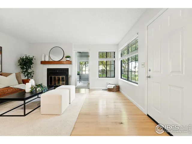 a living room with furniture a window and a fireplace