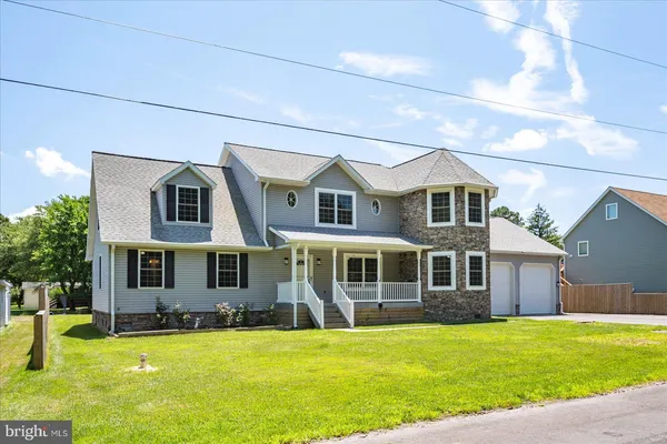 a front view of a house with a yard table and chairs