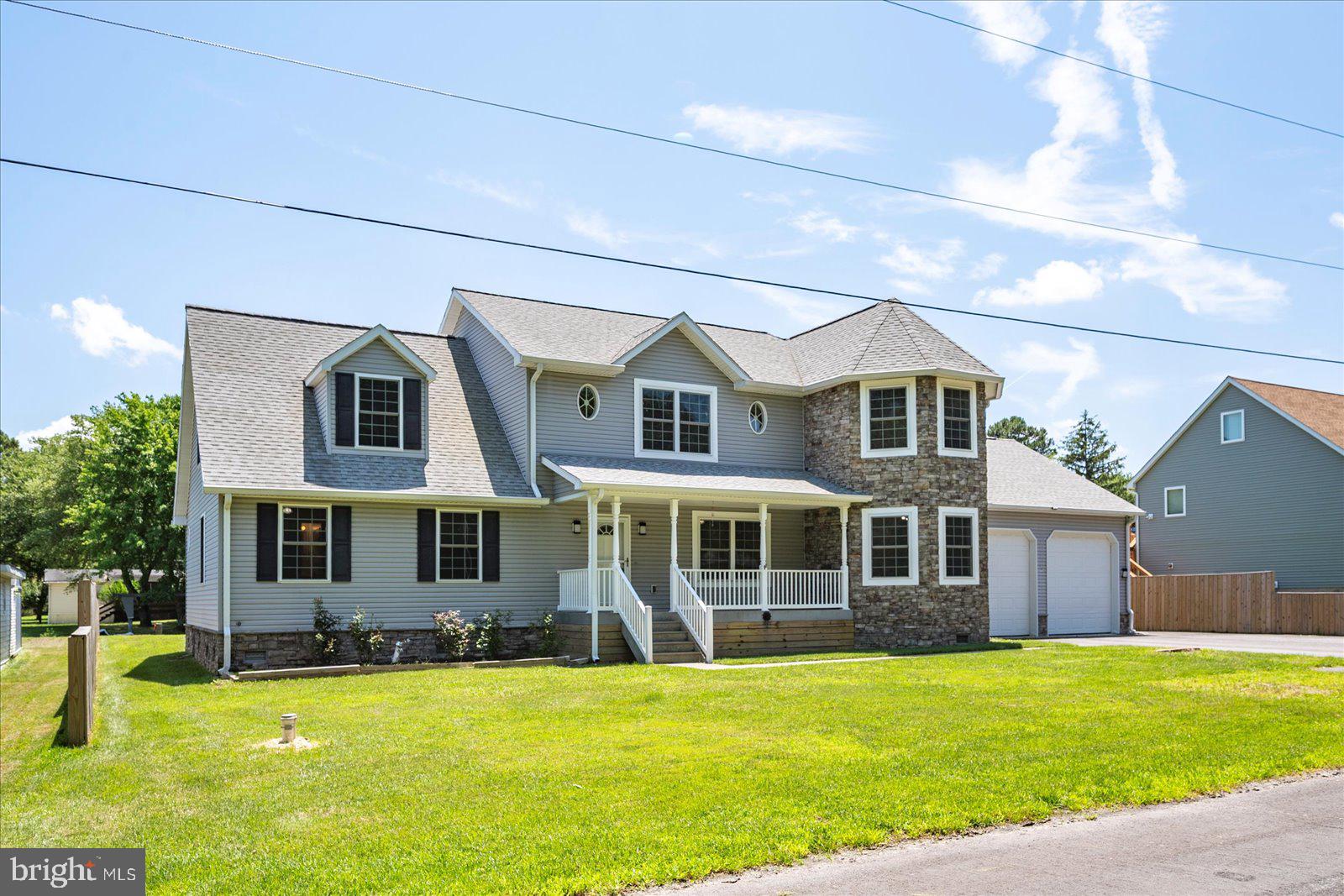 a front view of a house with a yard table and chairs