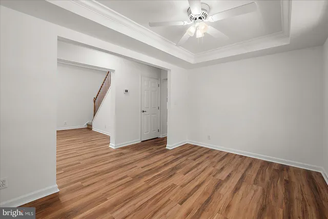 a view of empty room with wooden floor