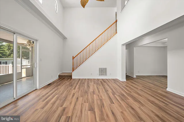 a large kitchen with stainless steel appliances granite countertop a stove a sink dishwasher and a microwave oven with wooden floor