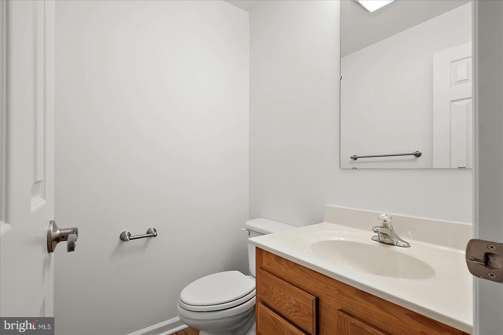 12212 Brant Road Bishopville, MD 21813 - Photo 27 of 69 a bathroom with a granite countertop sink a toilet and a mirror