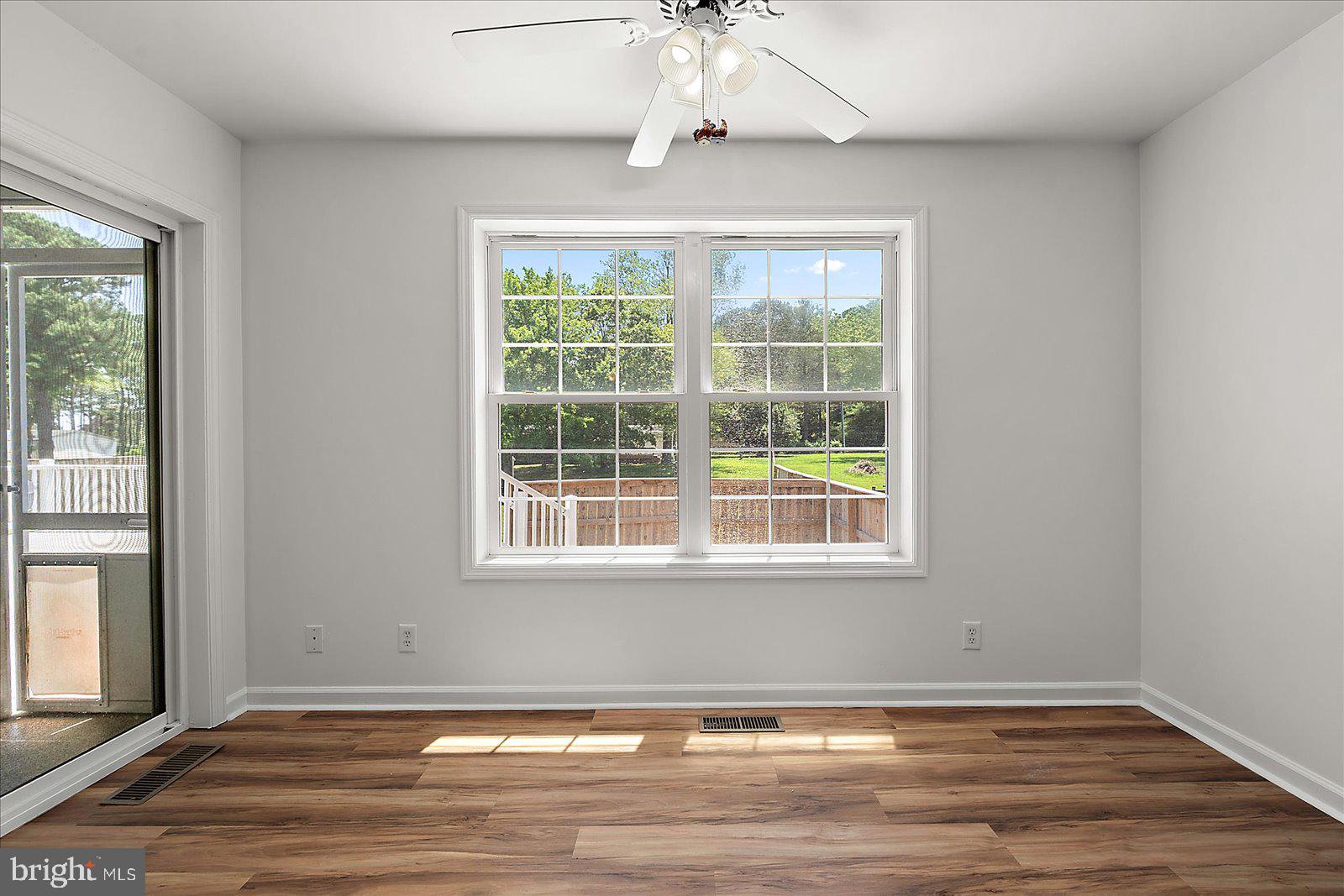 12212 Brant Road Bishopville, MD 21813 - Photo 28 of 69 an empty room with wooden floor and windows