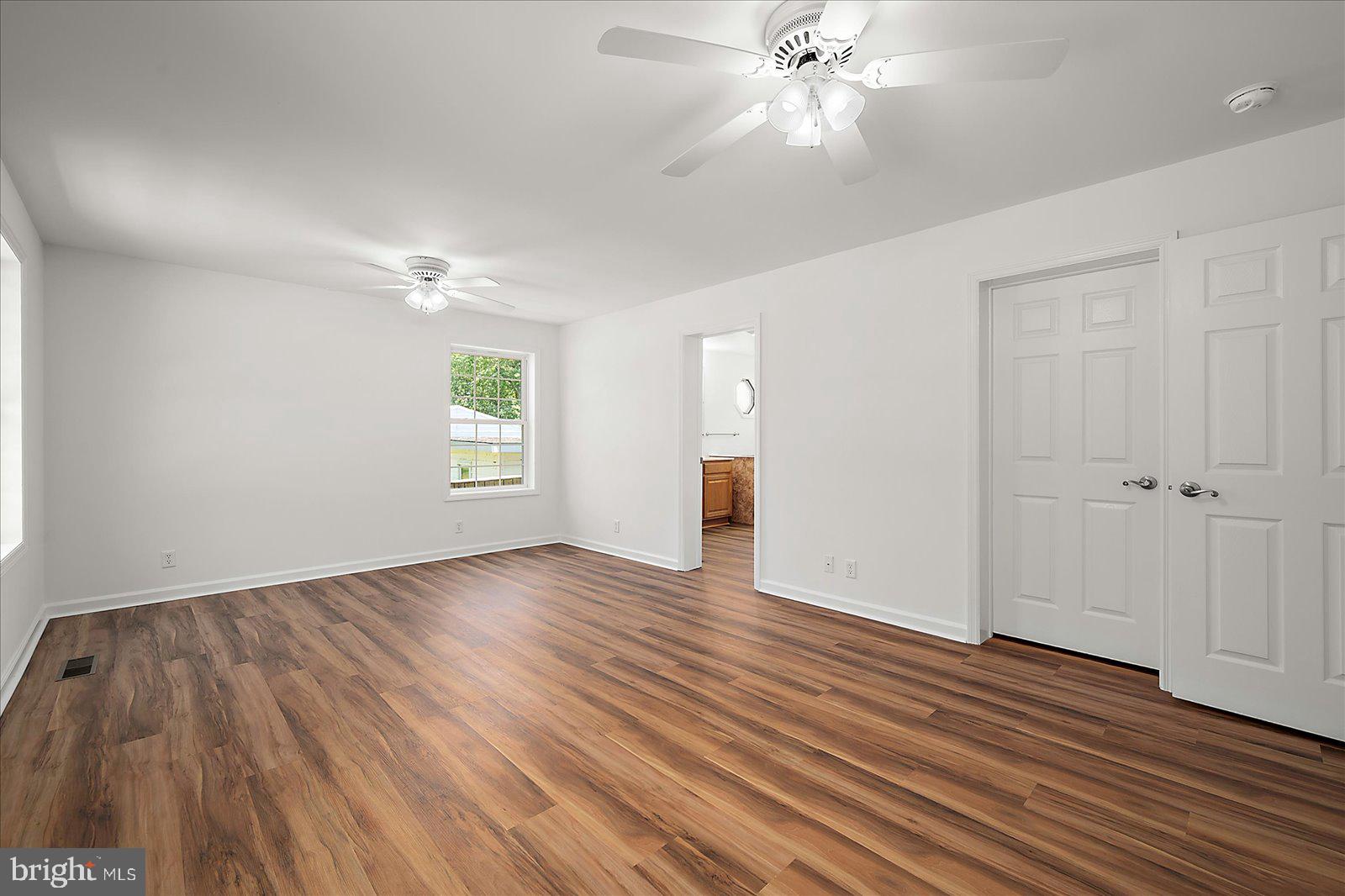 12212 Brant Road Bishopville, MD 21813 - Photo 31 of 69 a view of an empty room with wooden floor and a window