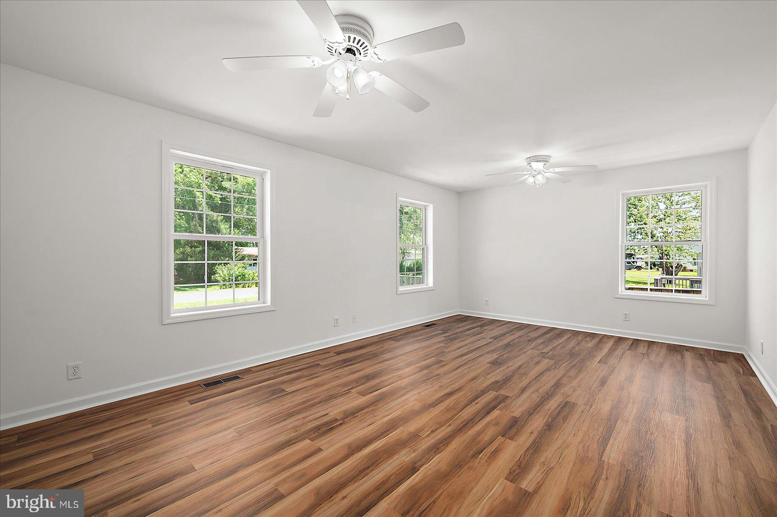 12212 Brant Road Bishopville, MD 21813 - Photo 32 of 69 a view of an empty room with wooden floor and a window