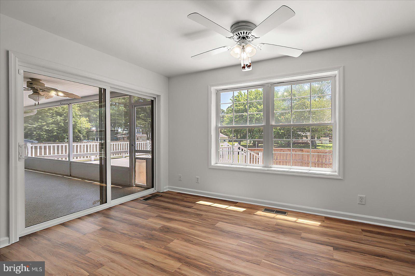 12212 Brant Road Bishopville, MD 21813 - Photo 33 of 69 a view of an empty room with wooden floor and a window