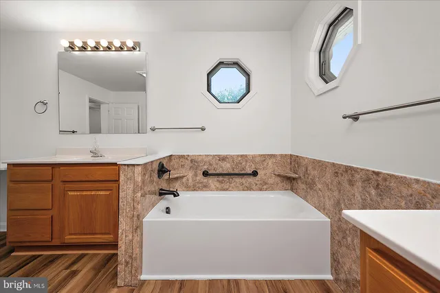 an empty room with a windows and ceiling fan