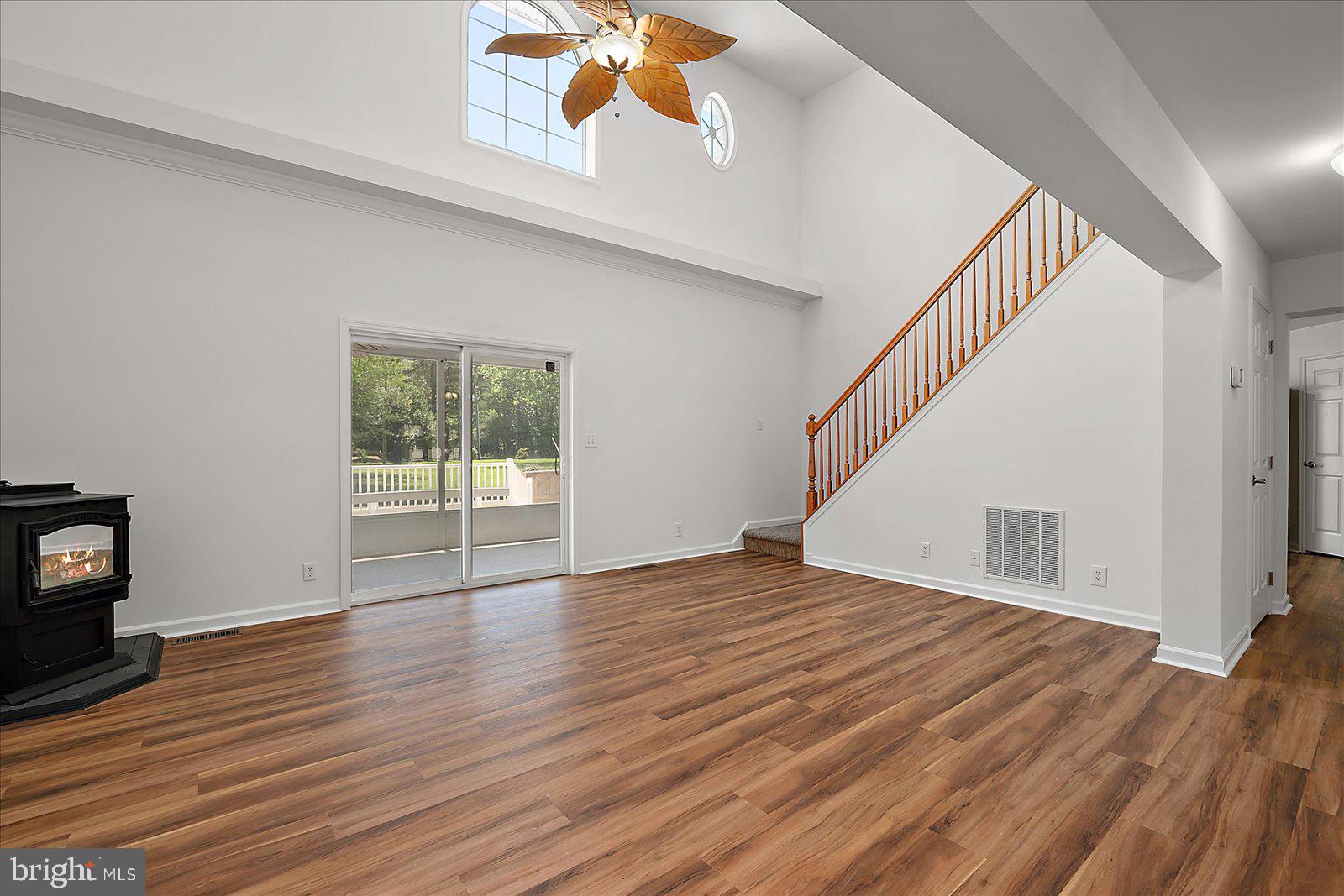 12212 Brant Road Bishopville, MD 21813 - Photo 9 of 69 a view of an empty room with wooden floor and a window