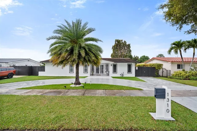 a house with swimming pool in front of it