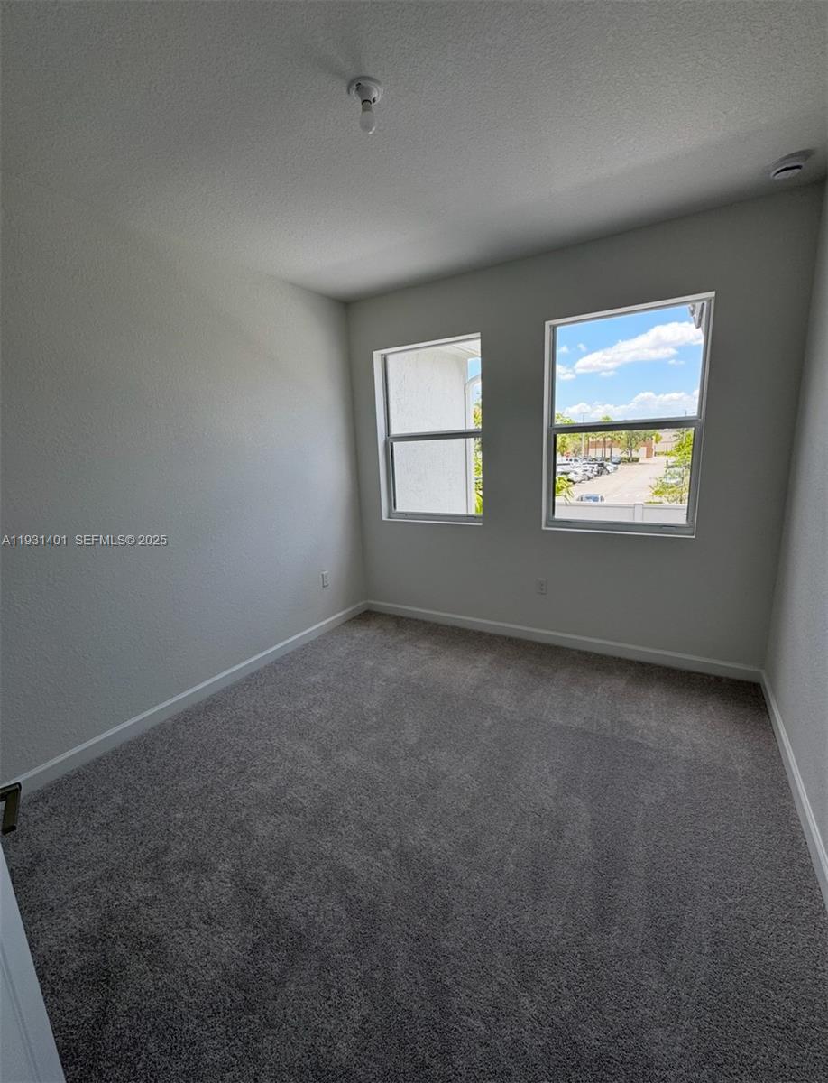 112 Southwest 184th Way, Unit 112 Pembroke Pines, FL 33029 - Photo 11 of 18 an empty room with windows