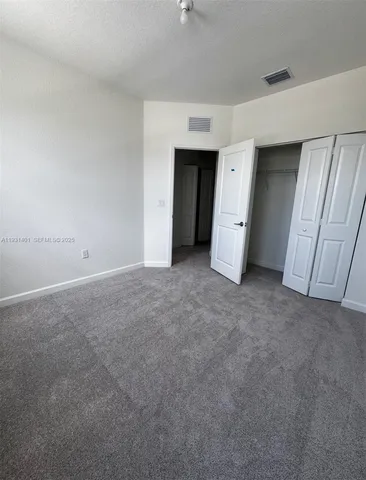 an empty room with a window and a fireplace