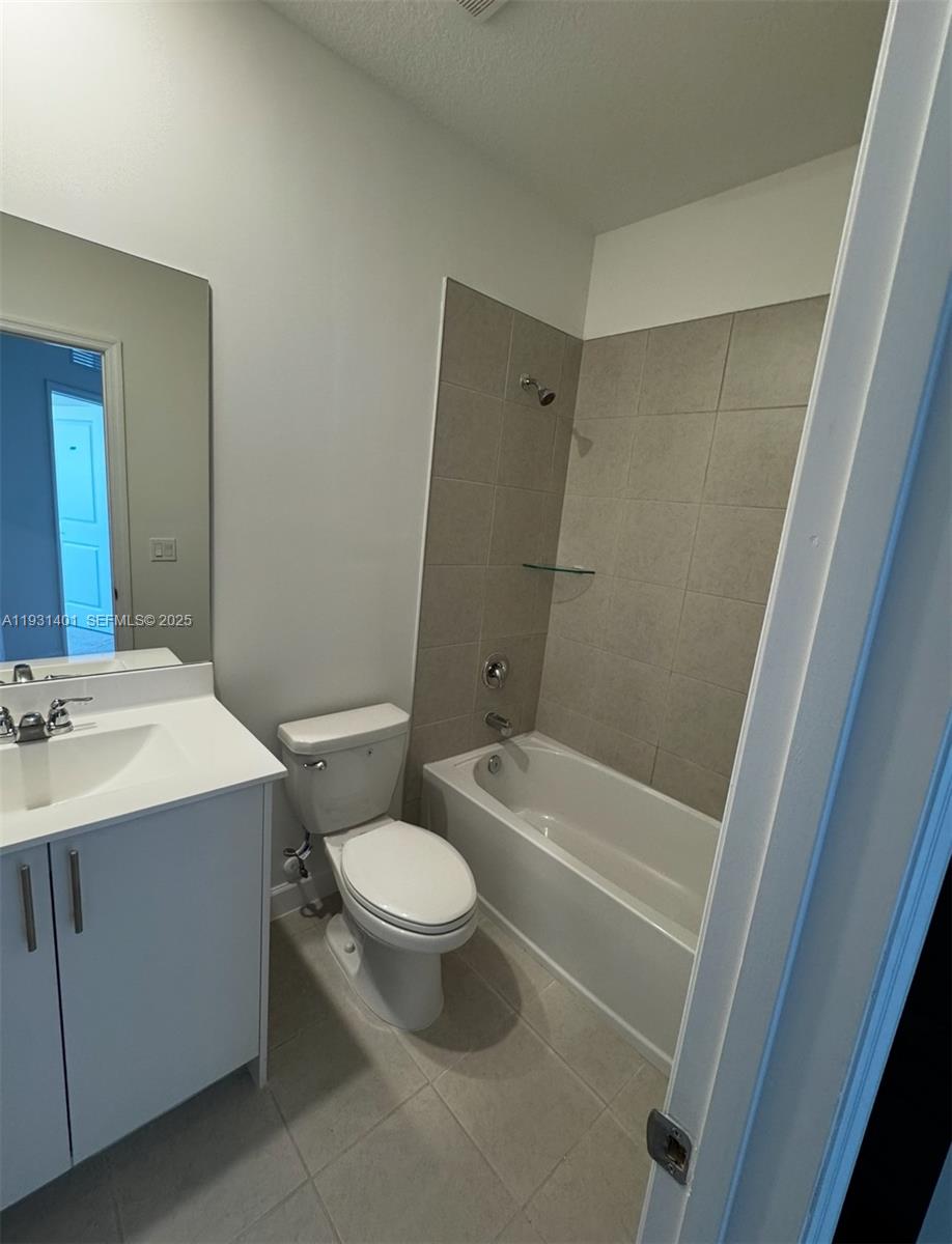 112 Southwest 184th Way, Unit 112 Pembroke Pines, FL 33029 - Photo 13 of 18 a bathroom with a sink a toilet a mirror a bathtub and shower