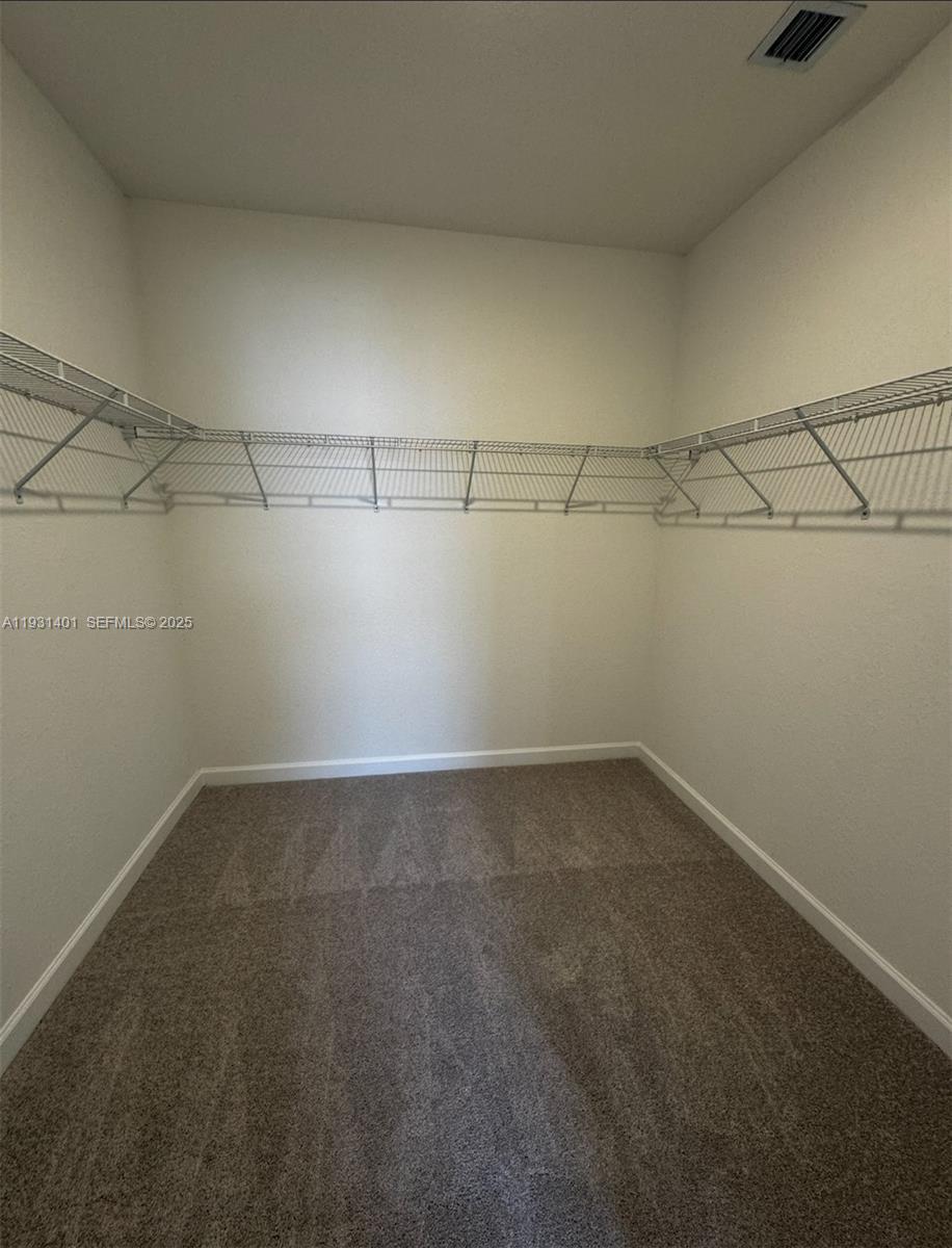 112 Southwest 184th Way, Unit 112 Pembroke Pines, FL 33029 - Photo 15 of 18 a view of a room with racks on the wall