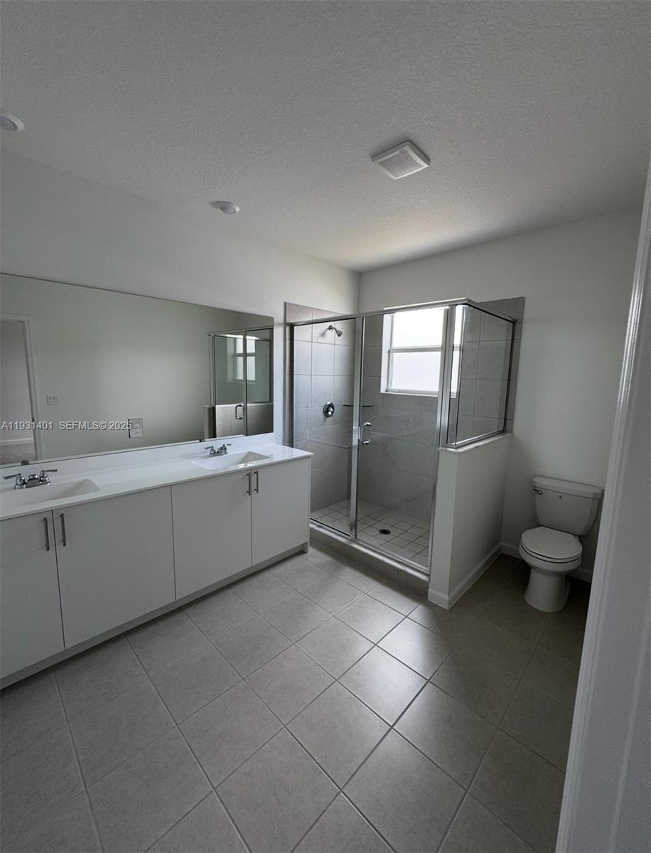 112 Southwest 184th Way, Unit 112 Pembroke Pines, FL 33029 - Photo 17 of 18 a bathroom with a double vanity sink and mirror