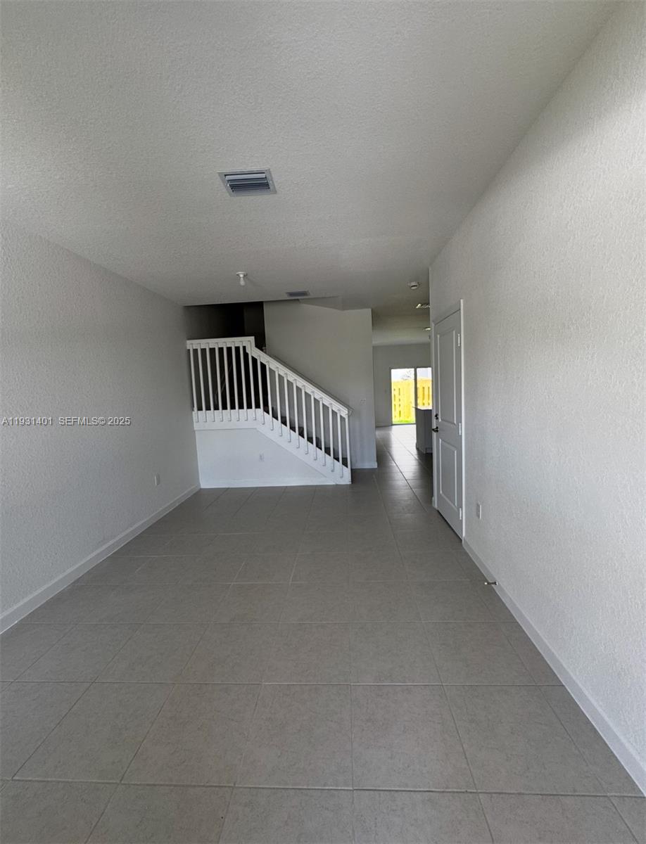 112 Southwest 184th Way, Unit 112 Pembroke Pines, FL 33029 - Photo 2 of 18 a view of an empty room and stairs