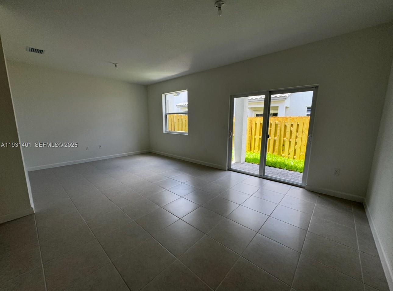 112 Southwest 184th Way, Unit 112 Pembroke Pines, FL 33029 - Photo 7 of 18 an empty room with a empty space and windows