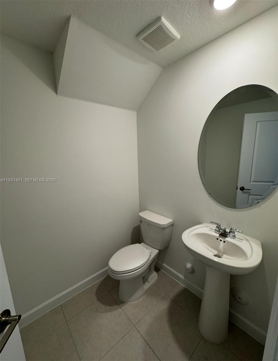 112 Southwest 184th Way, Unit 112 Pembroke Pines, FL 33029 - Photo 8 of 18 a bathroom with a sink toilet and a mirror