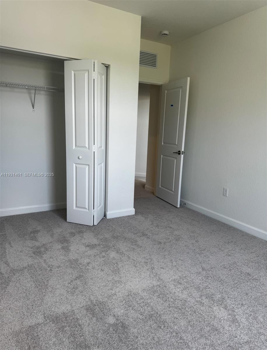 112 Southwest 184th Way, Unit 112 Pembroke Pines, FL 33029 - Photo 9 of 18 an empty room with a door