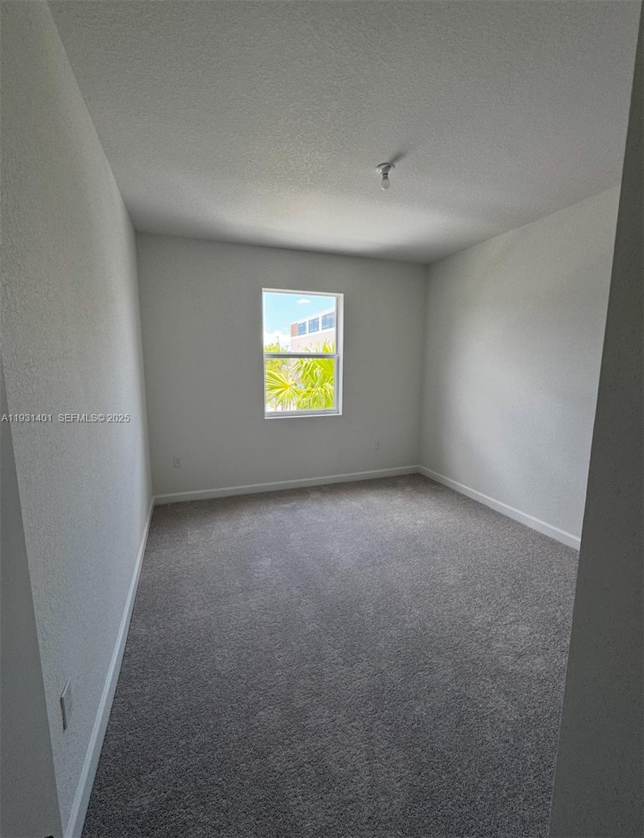 112 Southwest 184th Way, Unit 112 Pembroke Pines, FL 33029 - Photo 10 of 18 a view of an empty room with window