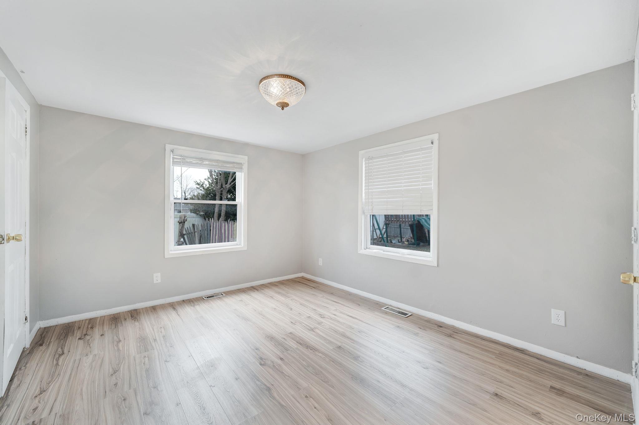 7 Kristin Court Bay Shore, NY 11706 - Photo 11 of 14 Spare room with light wood-type flooring and baseboards