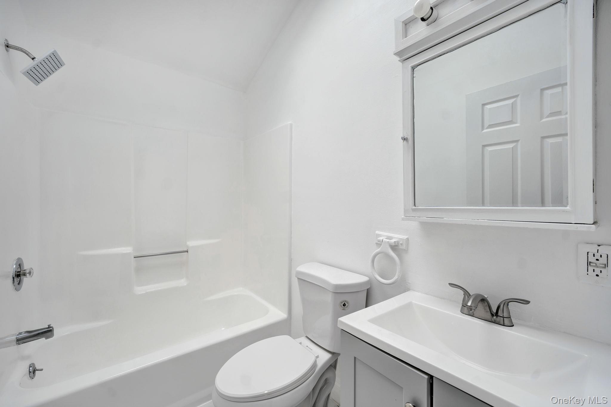 7 Kristin Court Bay Shore, NY 11706 - Photo 12 of 14 Bathroom featuring vanity, shower combination, and vaulted ceiling