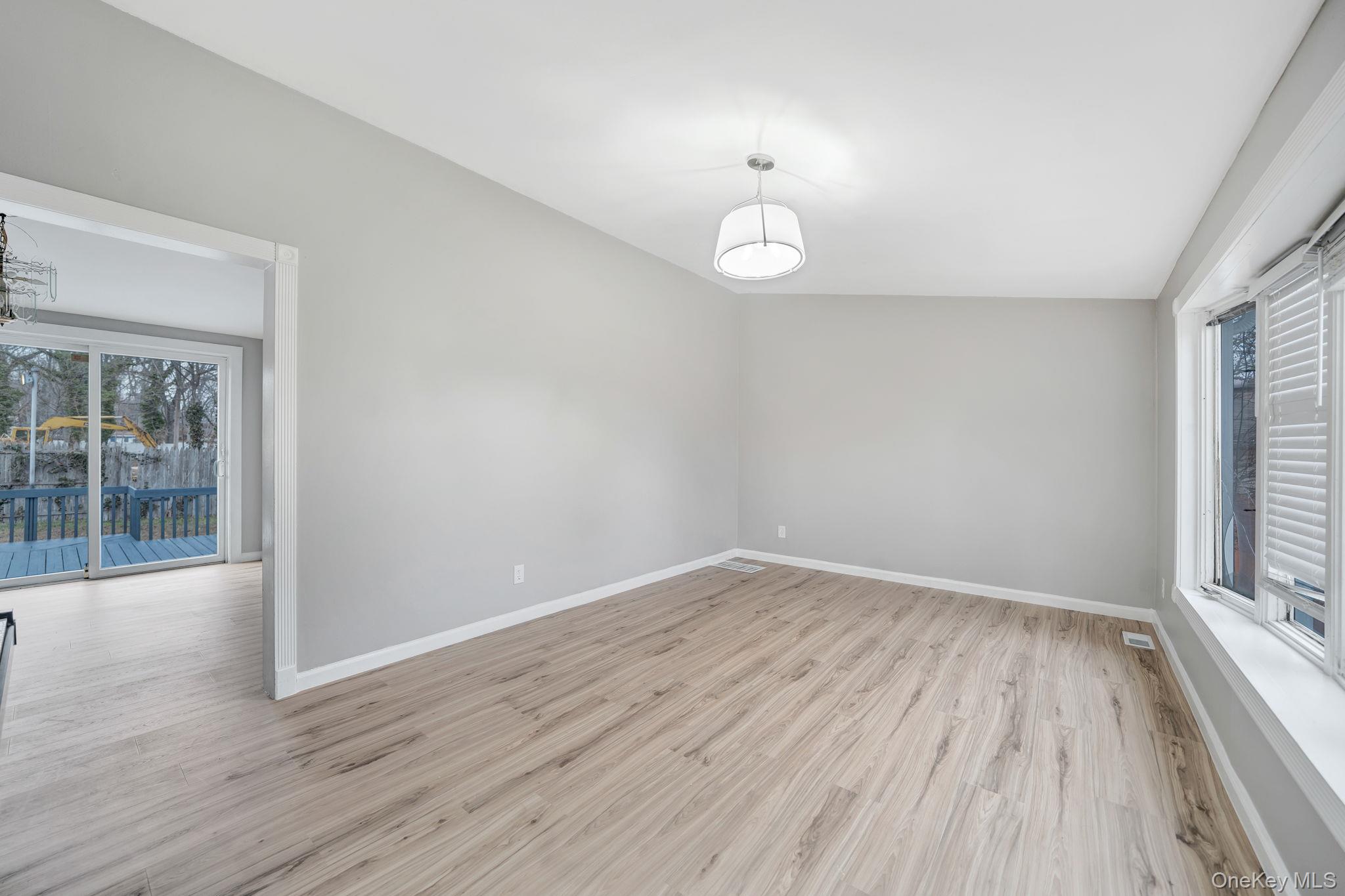 7 Kristin Court Bay Shore, NY 11706 - Photo 6 of 14 Empty room featuring plenty of natural light and light wood-style flooring