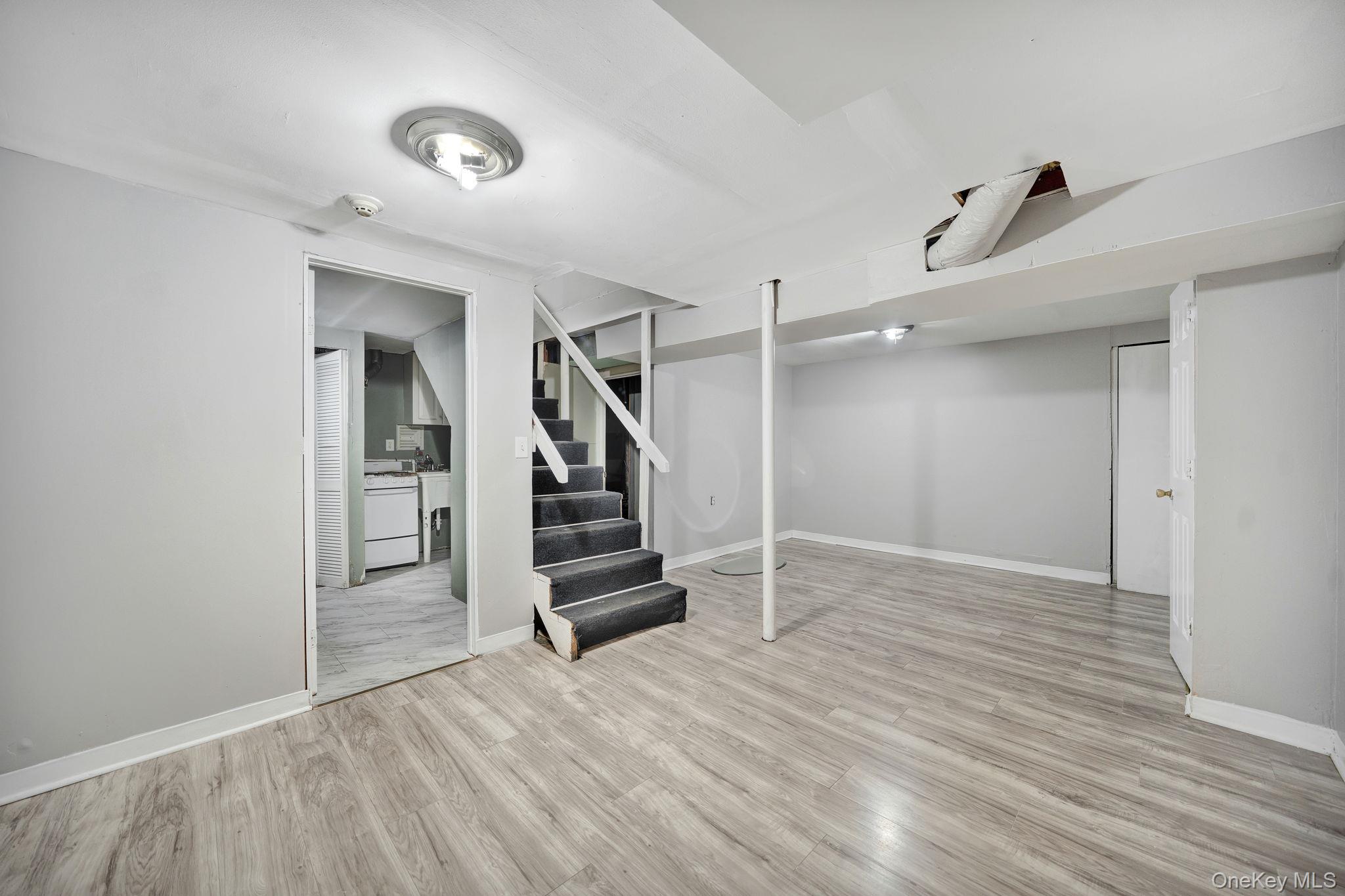 7 Kristin Court Bay Shore, NY 11706 - Photo 10 of 14 Finished basement with stairway and light wood-type flooring