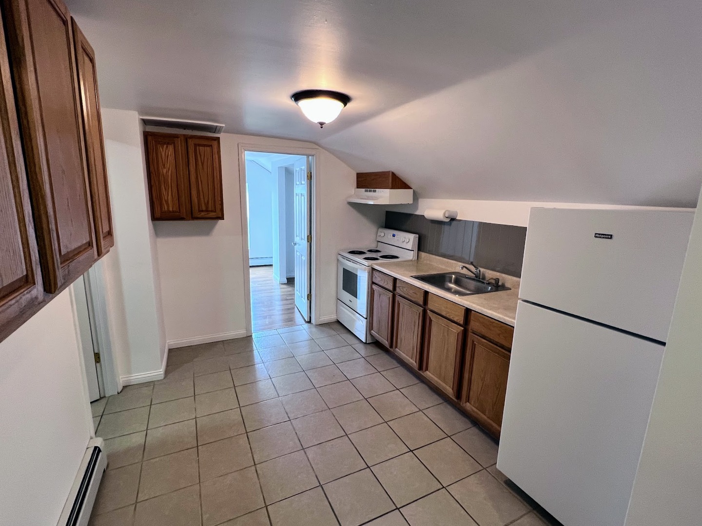 218 South Church Street, Unit 4 Wauconda, IL 60084 - Photo 3 of 11 a kitchen with stainless steel appliances a refrigerator stove and sink