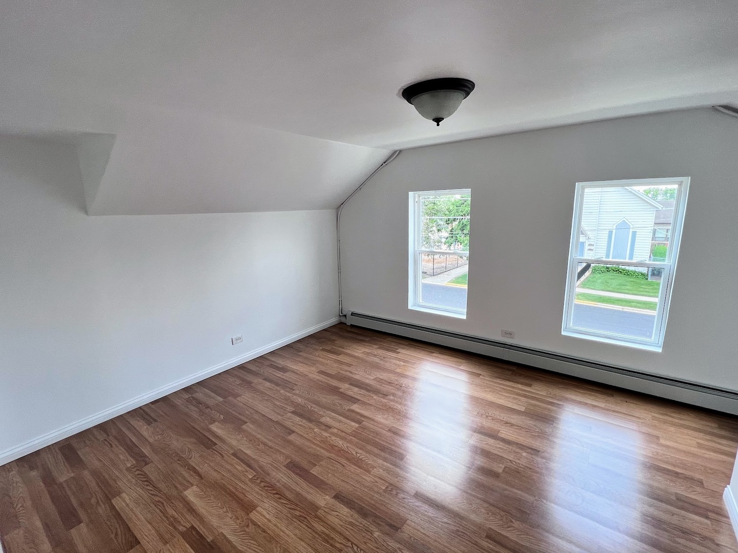 218 South Church Street, Unit 4 Wauconda, IL 60084 - Photo 6 of 11 an empty room with wooden floor and windows
