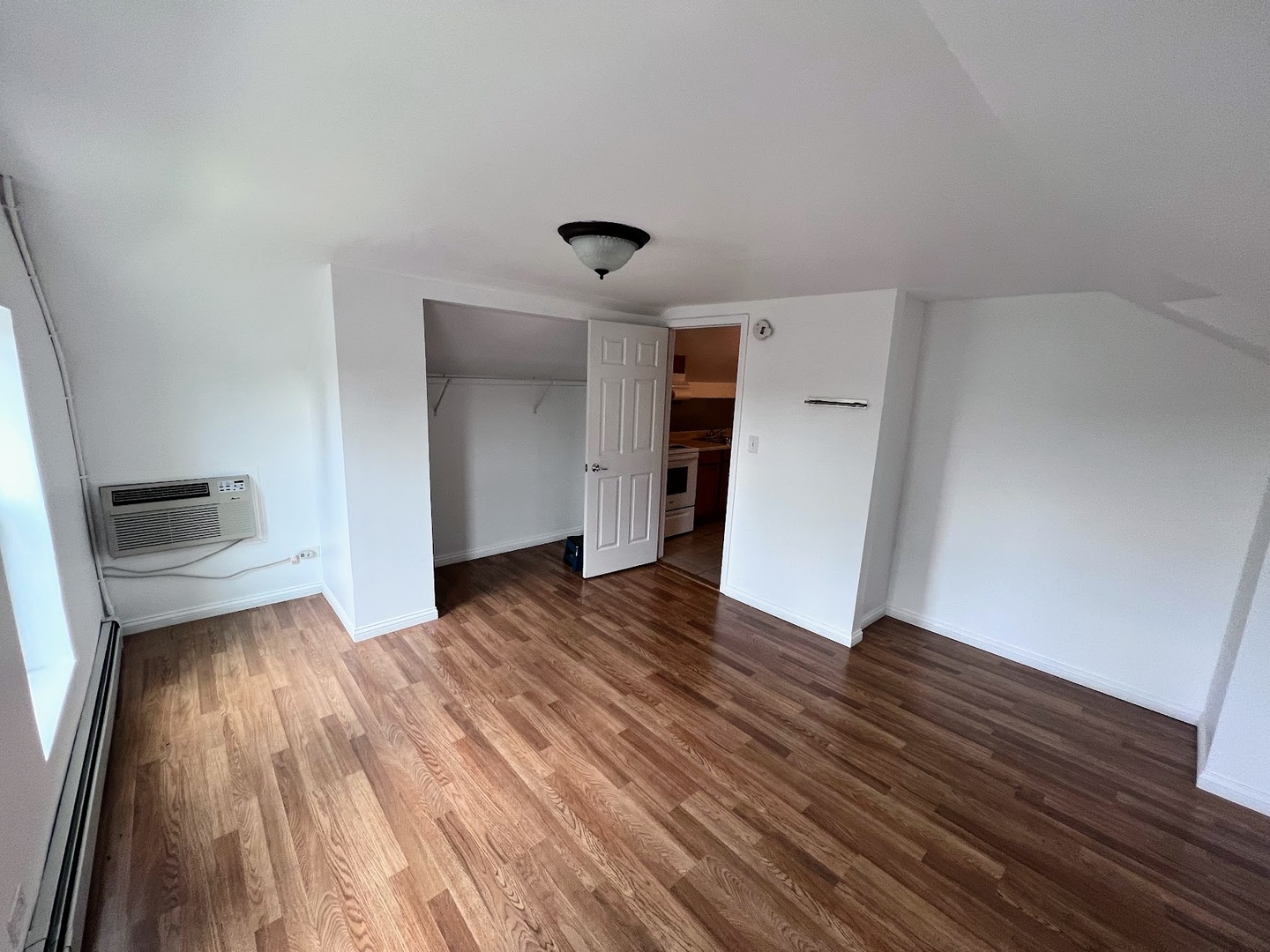 218 South Church Street, Unit 4 Wauconda, IL 60084 - Photo 8 of 11 a view of empty room with wooden floor and window