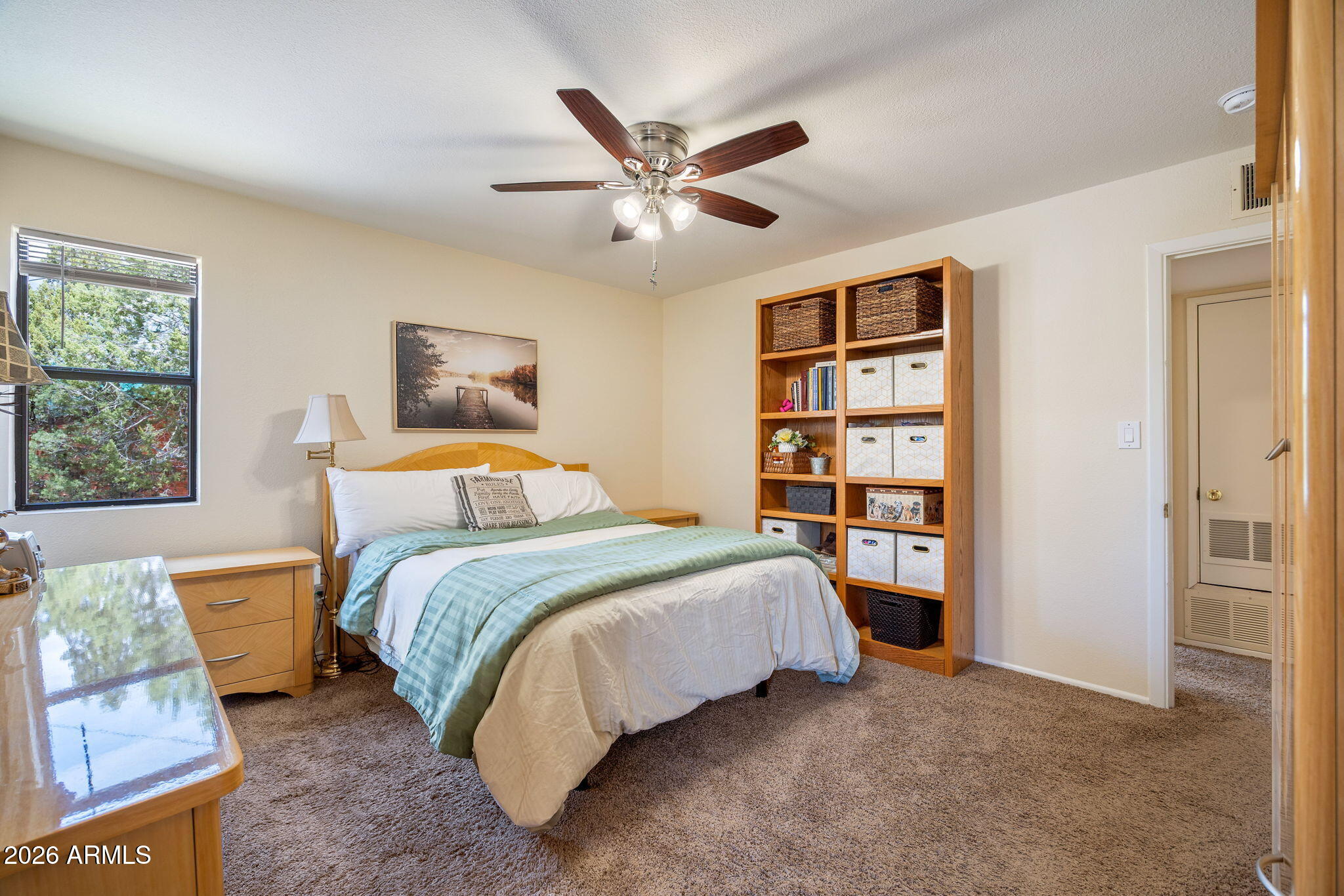 3384 Turkey Run Overgaard, AZ 85933 - Photo 20 of 37 a bedroom with a bed and a chandelier