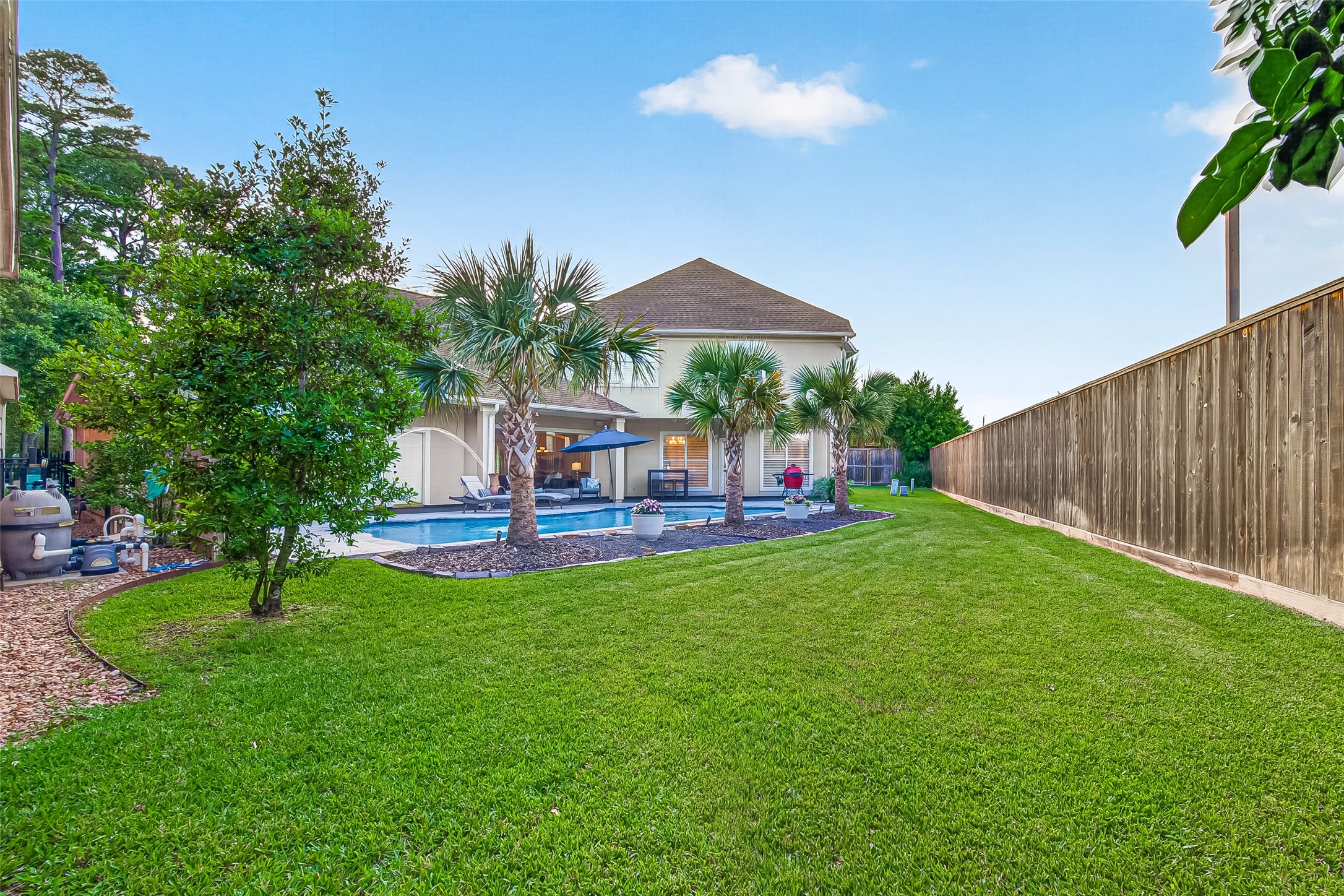 22 Stonegate Park Court Spring, TX 77379 - Photo 45 of 49 Wider angle view of left rear of the backyard which does include green space in addition to the pool.