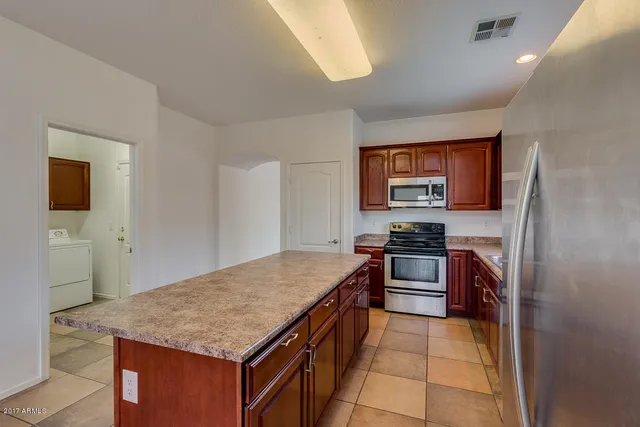 a kitchen with stainless steel appliances granite countertop a stove top oven a sink and dishwasher