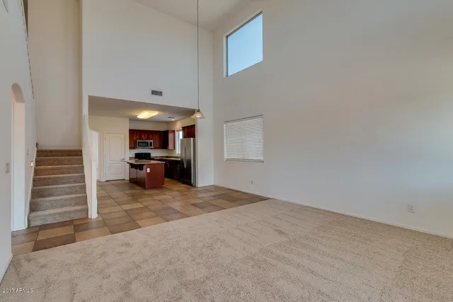 a view of a hallway with stairs and a wooden floor